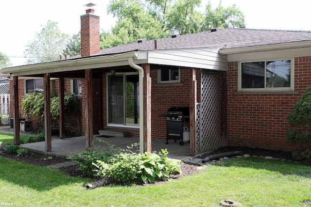 31717 Tecla St, Warren, MI 48088 - rear view of house with brick siding, a patio area, a chimney, roof with shingles, and a yard