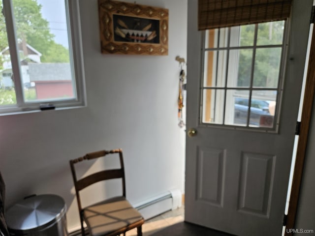 505 Pennsylvania Ave, Ontonagon, MI 49953 - doorway with baseboard heating, plenty of natural light, and dark tile patterned flooring