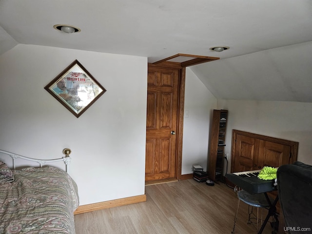 505 Pennsylvania Ave, Ontonagon, MI 49953 - bedroom with lofted ceiling and light wood-style floors