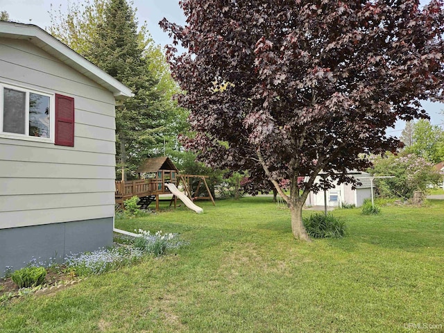 505 Pennsylvania Ave, Ontonagon, MI 49953 - view of green lawn with a playground and a storage unit