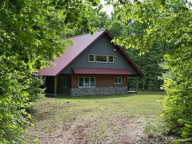 23505 Craig Lake Rd, Michigamme, MI 49861 - chalet / cabin with a standing seam roof, a metal roof, and a front yard