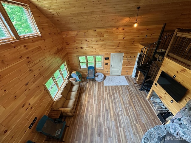 23505 Craig Lake Rd, Michigamme, MI 49861 - unfurnished living room featuring plenty of natural light, wood finished floors, wooden walls, and wood ceiling