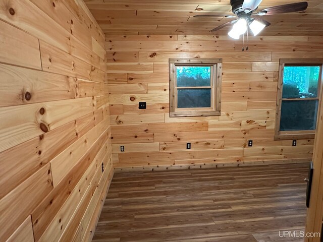 23505 Craig Lake Rd, Michigamme, MI 49861 - empty room featuring wooden walls, a relaxing sauna, a ceiling fan, and wood finished floors