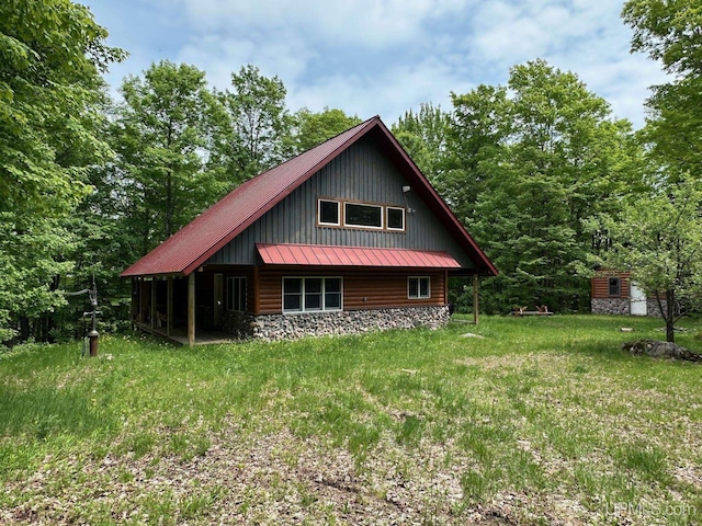 23505 Craig Lake Rd, Michigamme, MI 49861 - view of front of house featuring a metal roof, a standing seam roof, and a storage unit