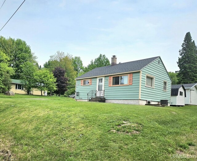 8199 Mill St, Ramsay, MI 49959 - view of front of property featuring a chimney and a front lawn
