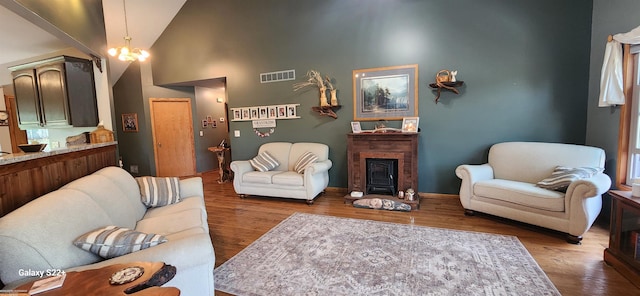 2793 Carina Dr, North Branch, MI 48461 - living area with a fireplace, high vaulted ceiling, and wood finished floors