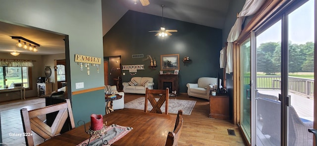 2793 Carina Dr, North Branch, MI 48461 - dining area with high vaulted ceiling, a ceiling fan, and light wood finished floors