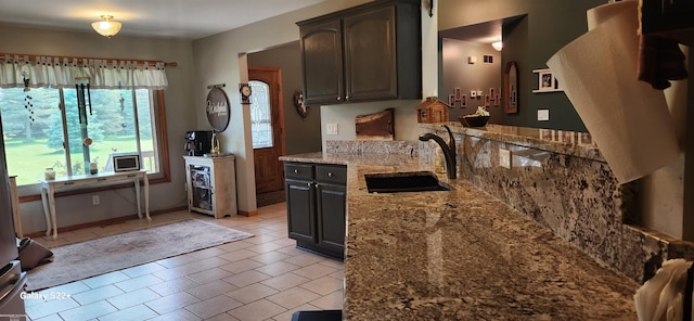 2793 Carina Dr, North Branch, MI 48461 - kitchen with light stone countertops, light tile patterned floors, and dark brown cabinets