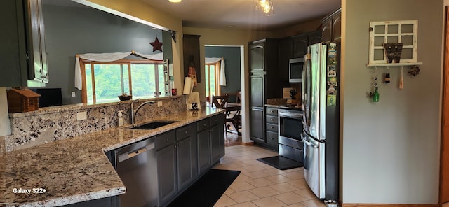 2793 Carina Dr, North Branch, MI 48461 - kitchen with appliances with stainless steel finishes, light tile patterned flooring, light stone countertops, and decorative backsplash