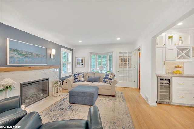 2080 Beaufait Dr, Grosse Pointe Woods, MI 48236 - living room with beverage cooler, light wood-type flooring, a dry bar, recessed lighting, and a premium fireplace