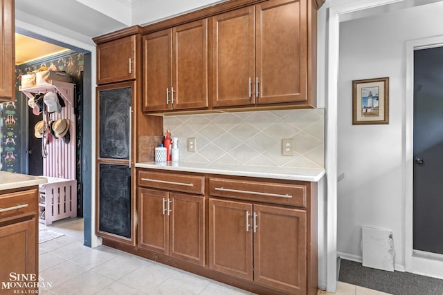1389 Bedford Rd, Grosse Pointe Park, MI 48230 - kitchen with backsplash, light countertops, and light tile patterned floors