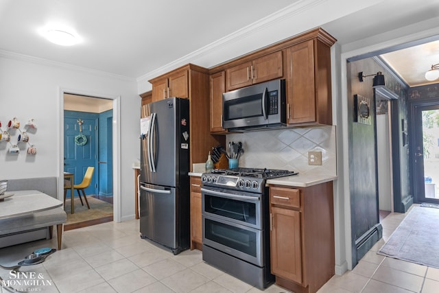 1389 Bedford Rd, Grosse Pointe Park, MI 48230 - kitchen featuring stainless steel appliances, light countertops, brown cabinetry, ornamental molding, and light tile patterned flooring