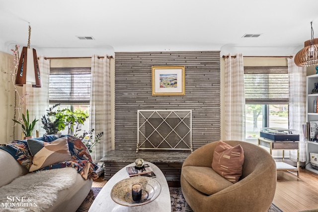 1389 Bedford Rd, Grosse Pointe Park, MI 48230 - living area with wood finished floors and a fireplace with raised hearth