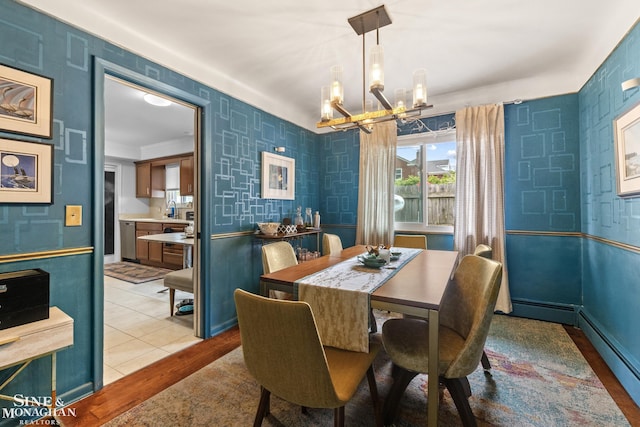 1389 Bedford Rd, Grosse Pointe Park, MI 48230 - dining room featuring a chandelier, baseboard heating, and light wood-style flooring