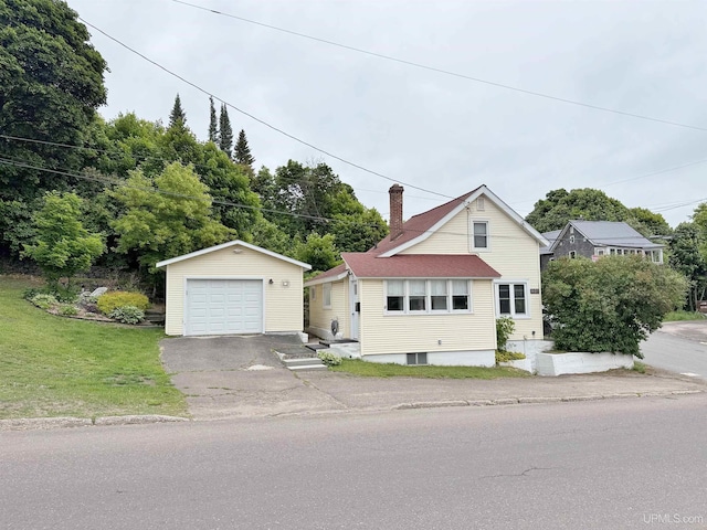 401 White St, Hancock, MI 49930 - view of front facade featuring a garage, an outbuilding, a chimney, asphalt driveway, and a front lawn