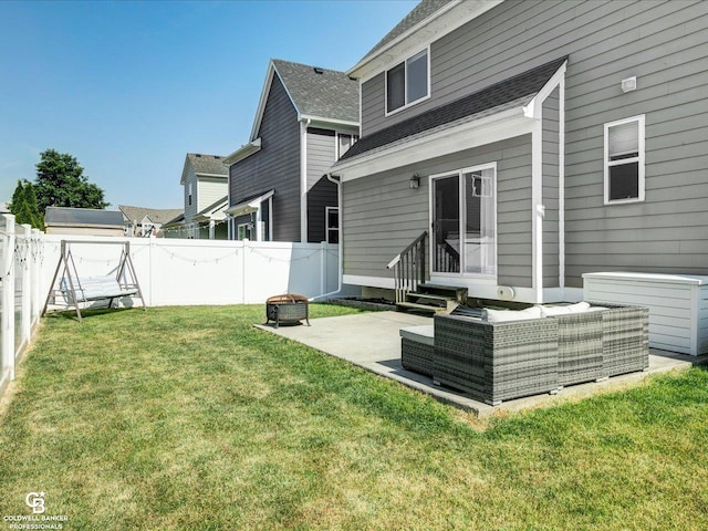 30569 Austin Ct, Chesterfield, MI 48051 - rear view of house with entry steps, a patio area, a fenced backyard, an outdoor living space with a fire pit, and a shingled roof