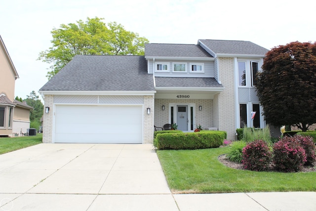 43980 Boulder Rd, Clinton Township, MI 48038 - view of front of house with a front lawn, an attached garage, a shingled roof, driveway, and brick siding