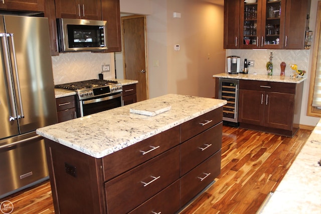 43980 Boulder Rd, Clinton Township, MI 48038 - kitchen with appliances with stainless steel finishes, wine cooler, dark wood-style floors, decorative backsplash, and glass insert cabinets