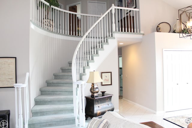 54640 Burlington Dr, Shelby Twp, MI 48315 - stairs with a high ceiling, a chandelier, and tile patterned flooring