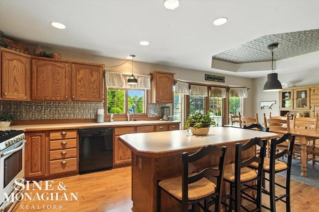 7119 Simons St, Lexington, MI 48450 - kitchen with dishwasher, stainless steel range with gas stovetop, healthy amount of natural light, light countertops, and recessed lighting
