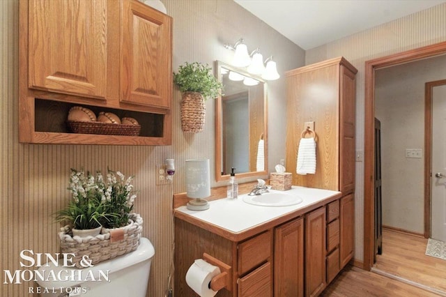 7119 Simons St, Lexington, MI 48450 - bathroom with vanity, wood finished floors, and wallpapered walls