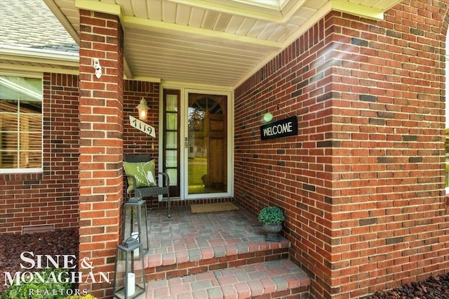 7119 Simons St, Lexington, MI 48450 - doorway to property featuring brick siding