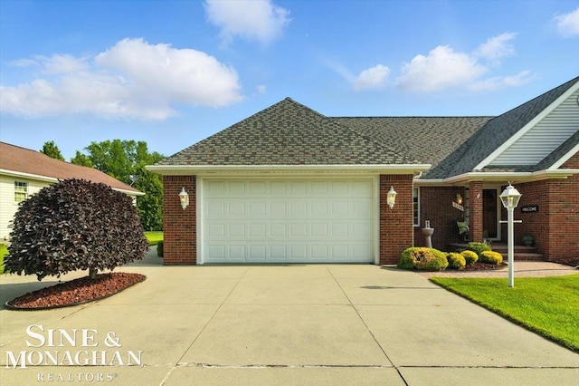 7119 Simons St, Lexington, MI 48450 - view of front facade with concrete driveway, brick siding, a garage, and roof with shingles