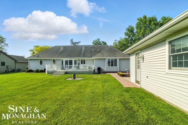 7119 Simons St, Lexington, MI 48450 - rear view of house featuring a lawn and a deck