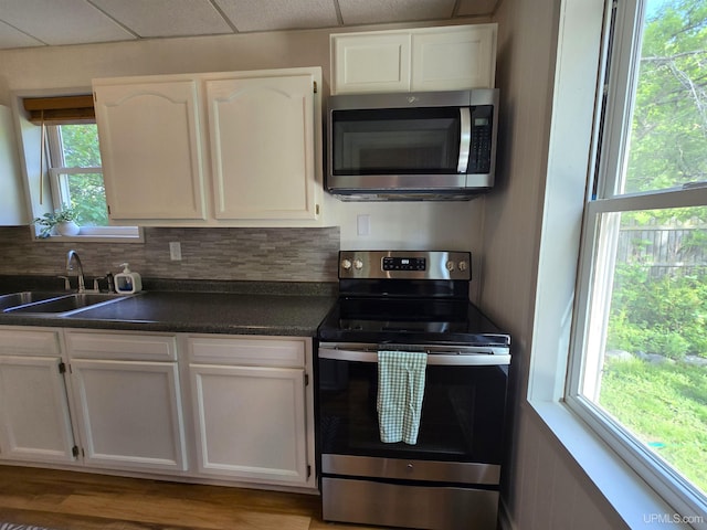 816 W Bluff St, Marquette, MI 49855 - kitchen featuring appliances with stainless steel finishes, white cabinets, and dark countertops