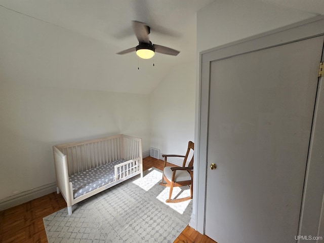 816 W Bluff St, Marquette, MI 49855 - bedroom featuring vaulted ceiling, a crib, and a ceiling fan