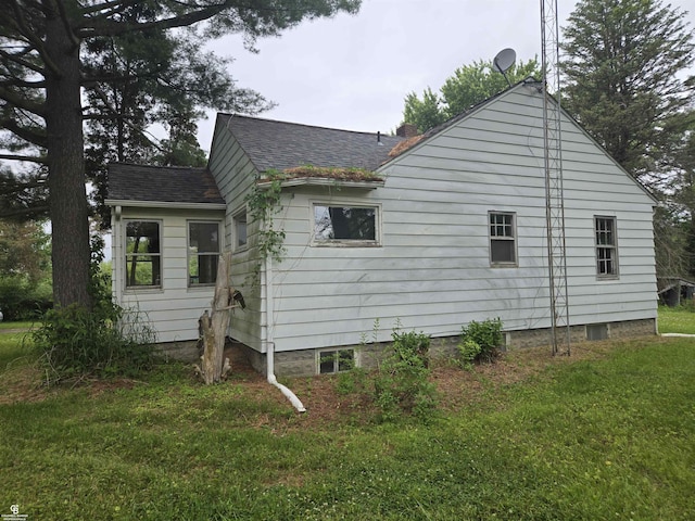 1675 Bauman Rd, Columbus, MI 48063 - view of side of property featuring a lawn and a shingled roof