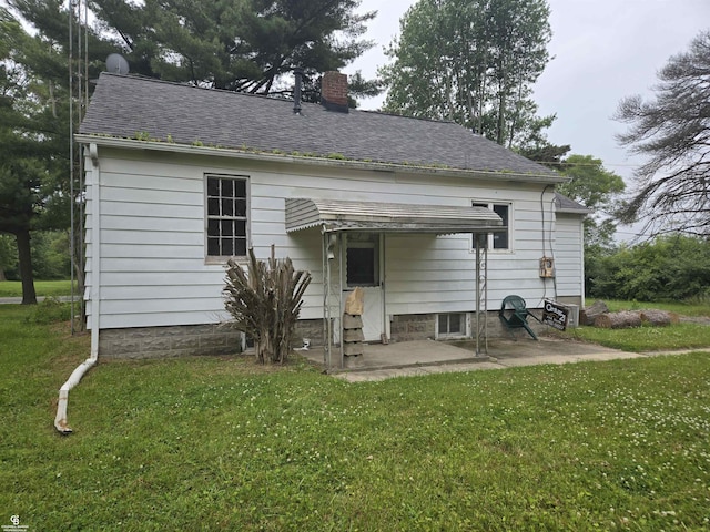 1675 Bauman Rd, Columbus, MI 48063 - rear view of property with a chimney, a lawn, a patio area, and roof with shingles