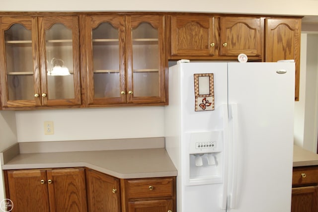 28117 Shock St, Saint Clair Shores, MI 48081 - kitchen with white fridge with ice dispenser, brown cabinetry, and light countertops