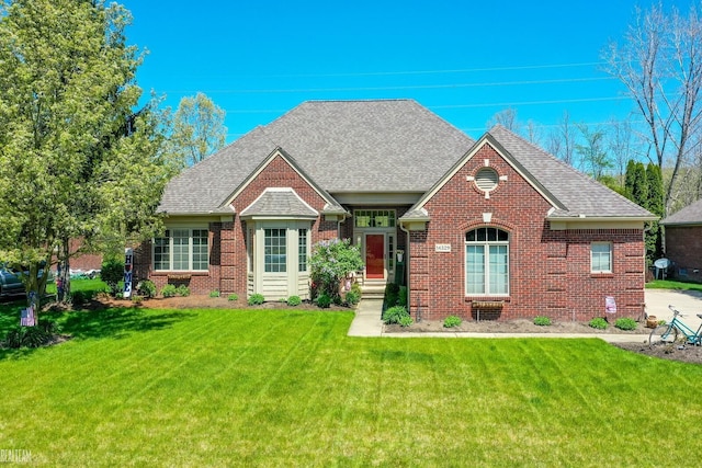 14329 Barton Dr, Washington Twp, MI 48094 - view of front of house featuring brick siding, a front lawn, and a shingled roof