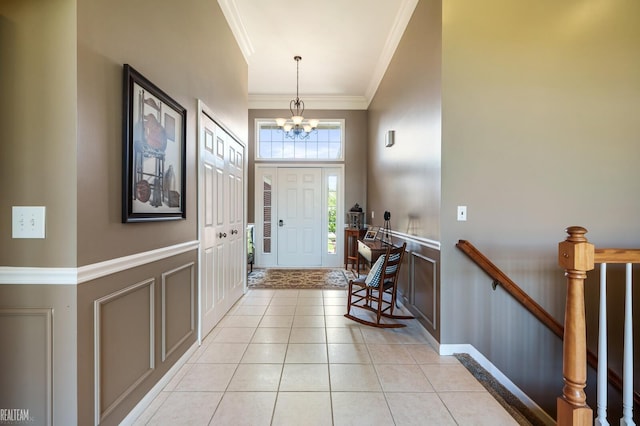 14329 Barton Dr, Washington Twp, MI 48094 - foyer entrance with a chandelier, ornamental molding, light tile patterned floors, and a towering ceiling