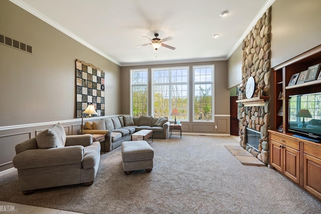 14329 Barton Dr, Washington Twp, MI 48094 - living room with ceiling fan, crown molding, a decorative wall, a fireplace, and plenty of natural light