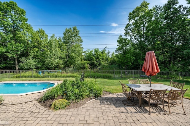 14329 Barton Dr, Washington Twp, MI 48094 - view of pool with a patio area, outdoor dining area, a fenced backyard, and view of wooded area