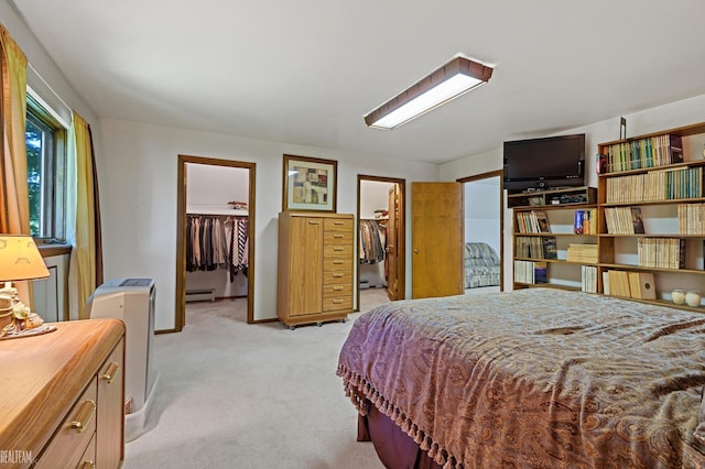 6499 Tubspring Rd, Almont, MI 48003 - bedroom with a spacious closet, light colored carpet, a baseboard radiator, and a closet