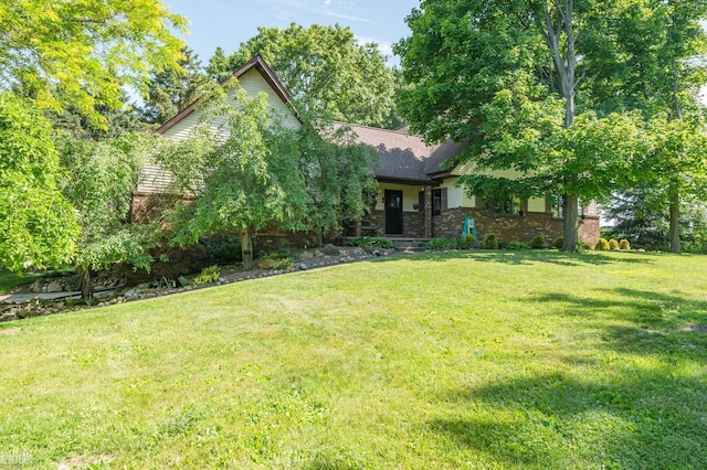 6499 Tubspring Rd, Almont, MI 48003 - view of property hidden behind natural elements with a front lawn and brick siding