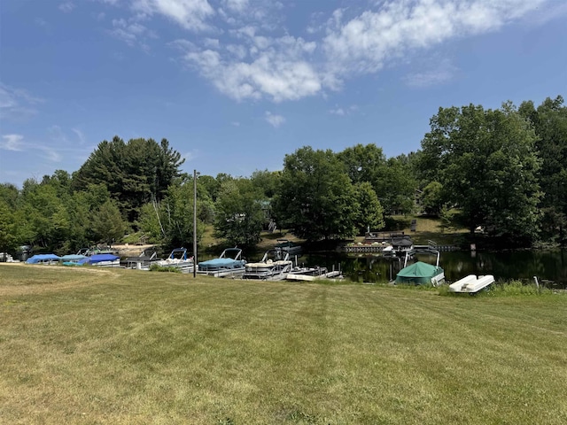 4110 Oak Ridge Dr, Harrison, MI 48625 - view of green lawn featuring a water view, a dock, and a forest view