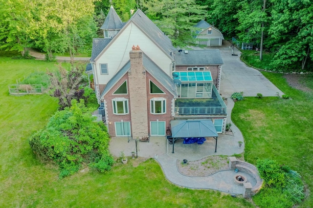 61801 Cetnor Ct, Washington, MI 48094 - back of property featuring a balcony, a lawn, an outdoor fire pit, an outdoor structure, and brick siding