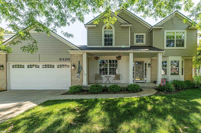 5320 Riverwalk Trl, Commerce Twp, MI 48382 - traditional-style house featuring brick siding, a porch, an attached garage, concrete driveway, and a front lawn