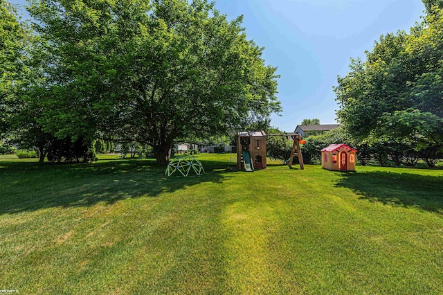 5320 Riverwalk Trl, Commerce Twp, MI 48382 - view of grassy yard featuring a playground and a storage shed