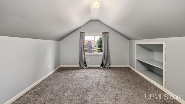 605 S 9th St, Escanaba, MI 49829 - additional living space featuring built in shelves, lofted ceiling, and carpet floors