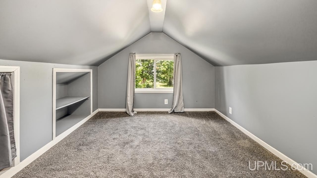 605 S 9th St, Escanaba, MI 49829 - additional living space with lofted ceiling and carpet