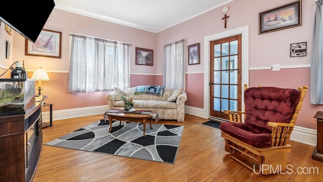 605 S 9th St, Escanaba, MI 49829 - living area with plenty of natural light, hardwood / wood-style flooring, and crown molding