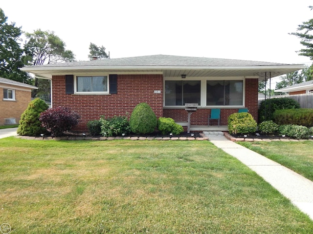 8508 Darlene St, Warren, MI 48093 - view of front facade with brick siding, a front lawn, and covered porch
