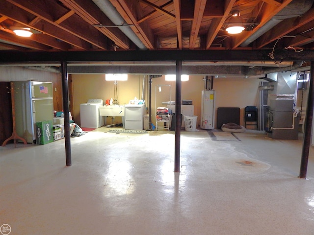 8508 Darlene St, Warren, MI 48093 - unfinished basement featuring water heater, independent washer and dryer, heating unit, and freestanding refrigerator