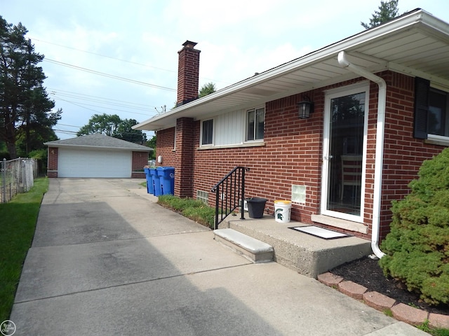 8508 Darlene St, Warren, MI 48093 - view of property exterior with brick siding, a chimney, an outbuilding, and a detached garage