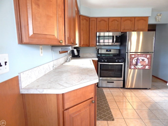 8508 Darlene St, Warren, MI 48093 - kitchen featuring appliances with stainless steel finishes, light countertops, brown cabinets, and light tile patterned flooring